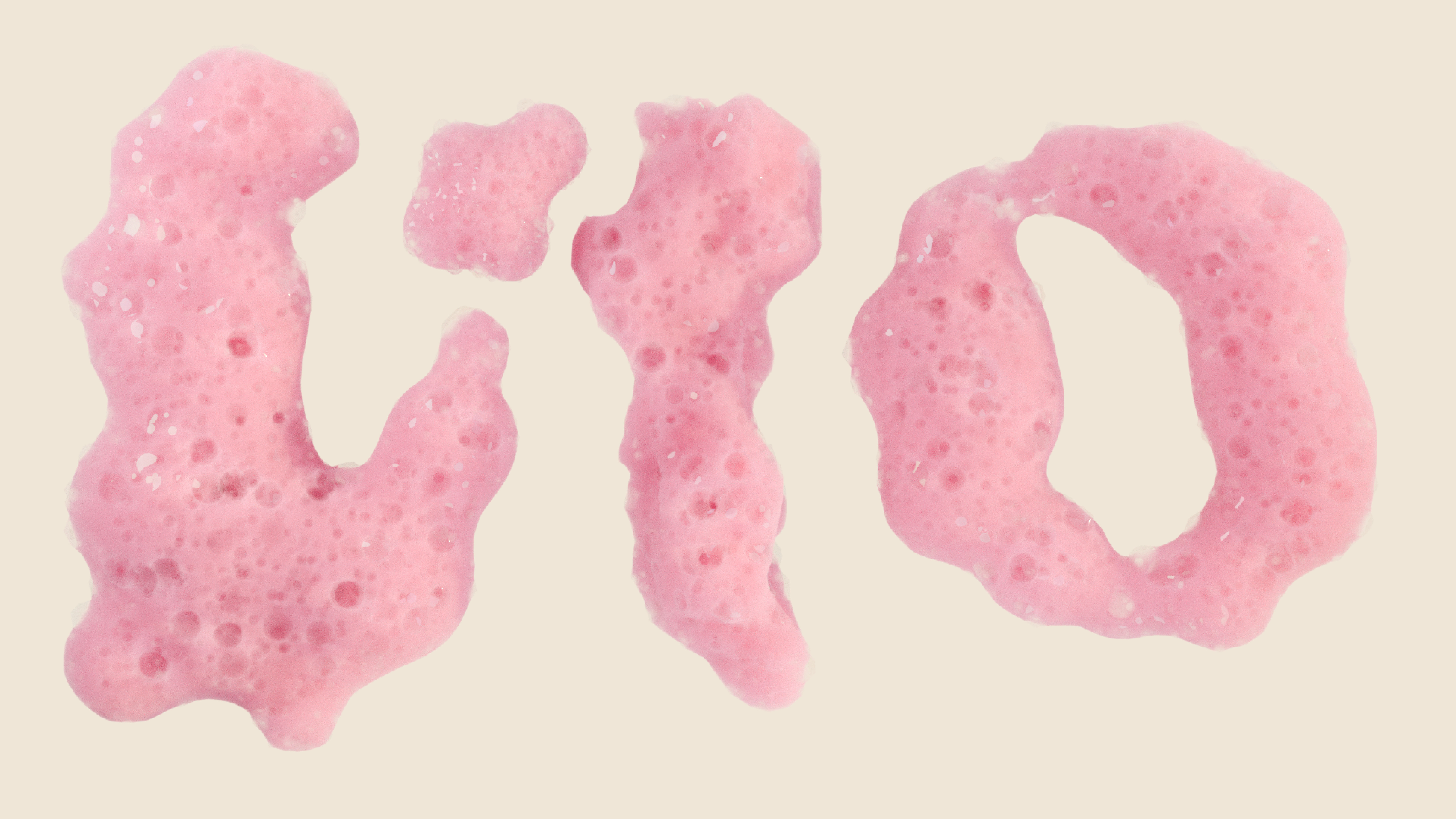 three dimensional logo made out of pink soap foam and bubbles